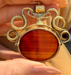 Antique yellow 18K swiveling double snake with urn carnelian pendant