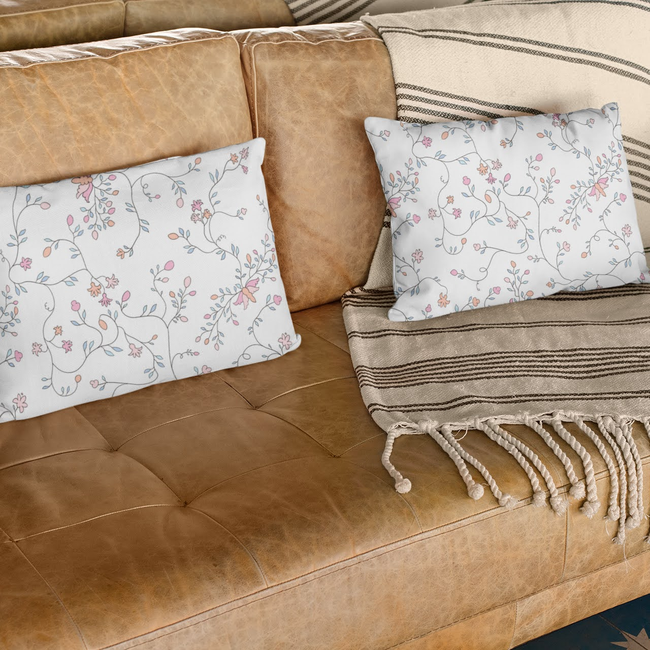 mockup-of-two-pillows-on-a-leather-sofa-with-books-on-the-side-29005.jpeg